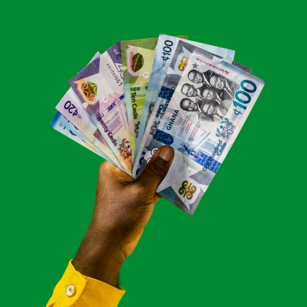 Hands holding Ghana cedi notes